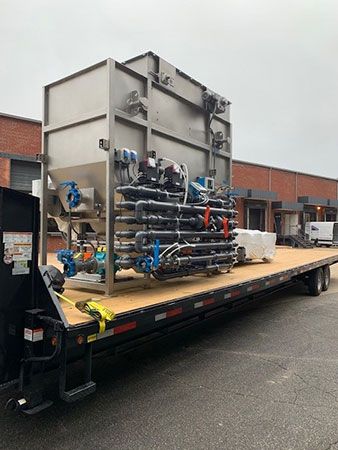 Skid-mounted DAF system pump manifold and chemical injection assembly.