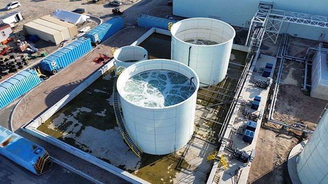 A robust outdoor equalization tank infrastructure integrated into a larger treatment system.
